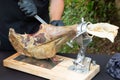 Knife cutting serrano chef man hand slicing of italian dry cured ham prosciutto Royalty Free Stock Photo