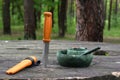 Knife and dishes of a tourist, hunter. Plastic dishes in the forest. Royalty Free Stock Photo