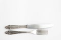 Knife, fork, fancy silver cutlery on white