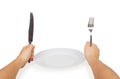 Knife and fork in hands and white plate Royalty Free Stock Photo