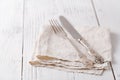 Knife, fork with linen serviette on the white background Royalty Free Stock Photo