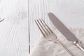 Knife, fork with linen serviette on the white background Royalty Free Stock Photo