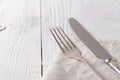 Knife, fork with linen serviette on the white background Royalty Free Stock Photo