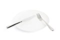 Knife and fork over the plate isolated Royalty Free Stock Photo