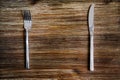 Knife and fork set on a wooden table Royalty Free Stock Photo