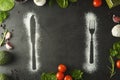 Knife and fork silhouette made with flour on dark background. Food frame concept. Copy space Royalty Free Stock Photo