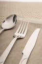 Knife, fork and spoon with linen serviette Royalty Free Stock Photo