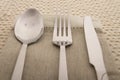 Knife, fork and spoon with linen serviette Royalty Free Stock Photo