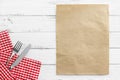 knife and fork on white old vintage wooden table with red checked tablecloth