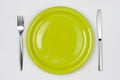 Knife, green plate and fork top view