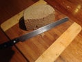 Knife and Homemade Bread on Rustic Wooden Board. Royalty Free Stock Photo