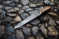 Knife lying on cobblestone street