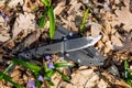 Knife with the plastic kydex sheath in the forest background