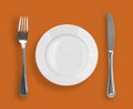 Knife, plate and fork on orange top view