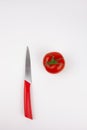 A knife with a red handle and juicy, fresh tomatoes Royalty Free Stock Photo