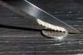 Knife rupiah coin on black wooden texture background Royalty Free Stock Photo