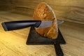A knife with a sharp blade for cutting bread, slicing a loaf of white fresh bread on a kitchen counter, a bread cutting board Royalty Free Stock Photo