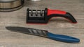 Knife Sharpener with Knife on the Kitchen Table Royalty Free Stock Photo