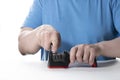 A knife sharpener. A man sharpens a knife on a special universal knife sharpener