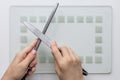 Knife and sharpener in woman hands sharpening on white background