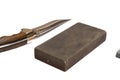 knife sharpening, knife on isolated white background with abrasive stone. Royalty Free Stock Photo