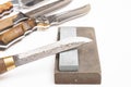 knife sharpening, knife on isolated white background with abrasive stone. Royalty Free Stock Photo