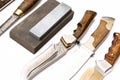 knife sharpening, knife on isolated white background with abrasive stone. Royalty Free Stock Photo