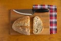 Knife and sliced bread on a cutting board.