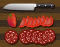 knife, sliced tomato and salami on wooden cutting board Royalty Free Stock Photo