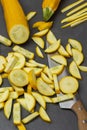 Knife and sliced yellow zucchini slices on the table Royalty Free Stock Photo