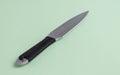Knife for throwing with a black winding of a handle. On a light