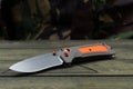 Knife for tourism and survival. Knife with an orange rubber handle. Military wooden box