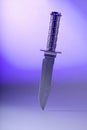 Knife on violet background