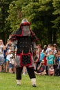 Valiant Knight in Armor Wields Mace and Shield: Epic Battle Reconstruction at the International Knights Festival