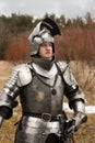 Knight in armour after battle on forest background