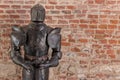 Knight armour with sword against brick wall background Royalty Free Stock Photo