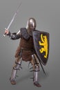 Knight in breaths in a helmet with a sword and shield in battle over grey background Royalty Free Stock Photo