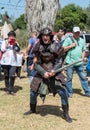 A knight festival participant dressed in a samurai costume prepared for a fight with a foam sword with a visitor in Goren park in