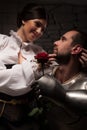 Knight giving a rose to lady