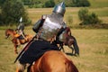 Knight on horse. Medieval armored equestrian soldiers. Riders are in the field