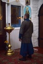 Knight in medieval chain mail dress and praying in church before an icon