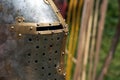 Knight metal helmet closeup on spears background. Historical reenactment