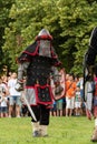 Brave Knight in Red Armor Wields Sword and Shield: Thrilling Battle Reconstruction at the International Knights Festival