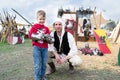 Knight shows the parts of medieval armor to a child