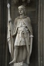 Knight statue at Cologne Cathedral with standard, sword and shield