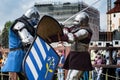 Knight tournament. The knights in the congregations are fighting in the ring. Public event in the city.