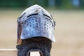 Knightly helmet on blurred background. Knightly combat armor_ Royalty Free Stock Photo