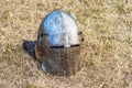 Knightly helmet on dry grass. Battle armor knight_