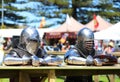 Knights in metal helmets and armor fight, a part of a costume performance at a Viking festival