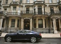 Knightsbridge residential and retail district in central Londonand a luxury Bentley car as a wealthy status symbol